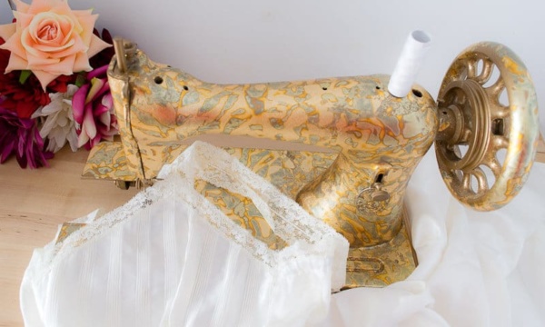 Use gold leaf and adhesive spray to decorate an old sewing machine